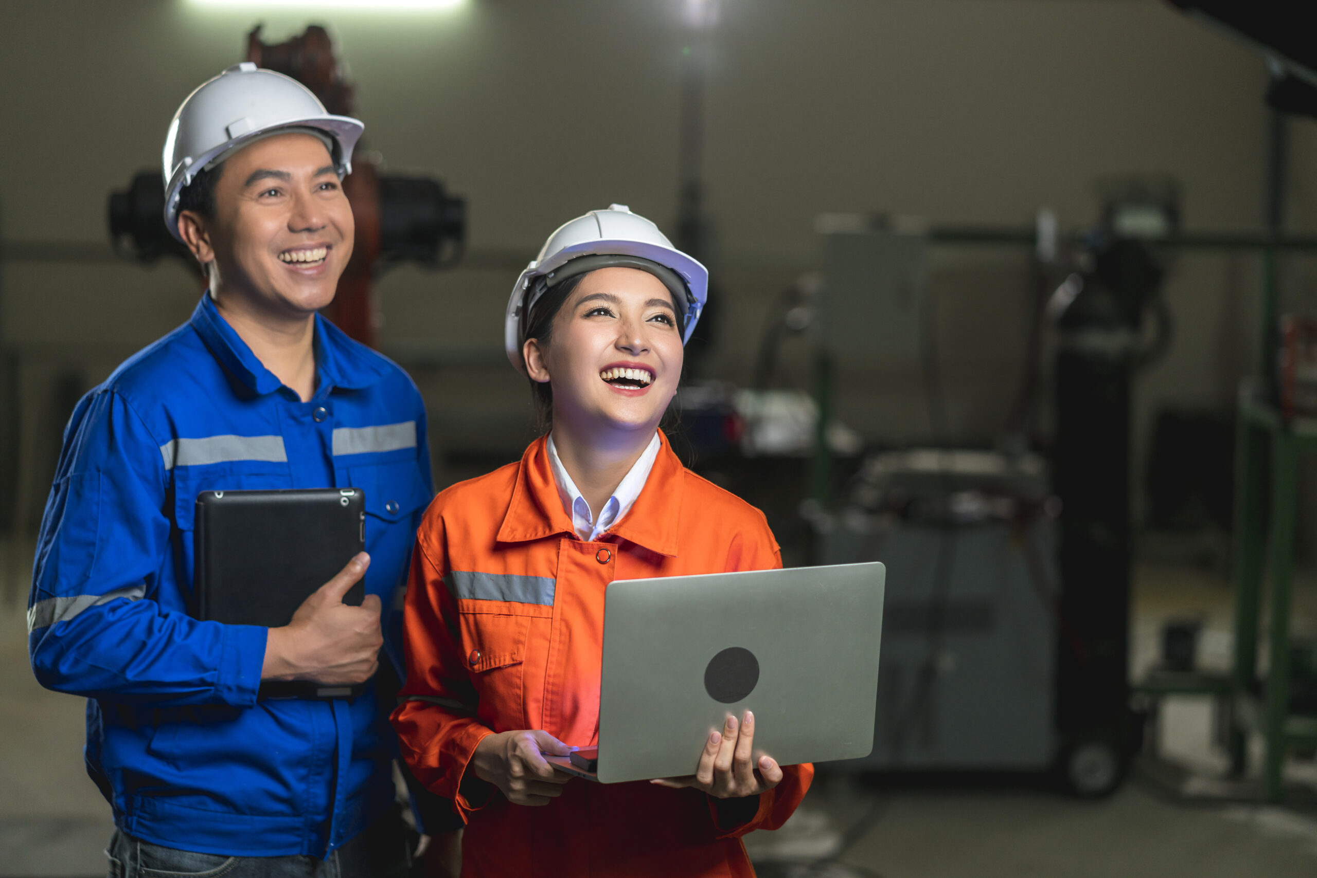 portrait-asian-emgineer-male-female-technician-safty-uniform-standing-turn-around-look-camera-laugh-smile-with-cheerful-confident-machinery-factory-workplace-background